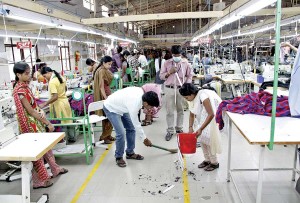 Workers cleaning their workplace to the background of motivational music in the local language – a daily practice at Madura for an allotted ten minutes