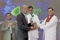 The Brandix Group's Head of Corporate Communications Anuk de Silva receives the award from Economic Development Minister Basil Rajapaksa in the presence of Minister of Technology, Research and Atomic Energy Patali Champika Ranawaka