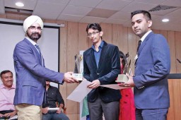 Harkirat Singh, MD, Woodland giving award to Ravi Shehkar and Subham Tilara