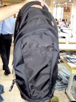 The front part of a backpack with the attached centre part, ready, to be fed into the final assembly line