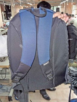 The back part of a backpack ready after the part preparation lines