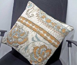 Cushion with multiple embroidery techniques