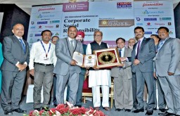 Madura Clothing team receiving the Golden Peacock Award for Corporate Social Responsibility for the year 2013. Nikhil Kumar, the then Governor of Kerala, gave away the awards