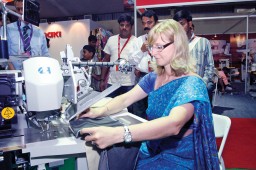 Karin Brinkmann, Area Segment Manager Garment, Duerkopp Adler demonstrating the 745-speed pocket machine