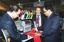 Girish K. (L), Branch Manager, Magnum Resources, explaining the working of Melco's AMAYA XTS latest embroidery machine. Also seen are Abhijat Mishra (R), Regional Manager (India, Middle East and Africa), Melco Industries and Peter Niedermann (M), International Sales Director 
