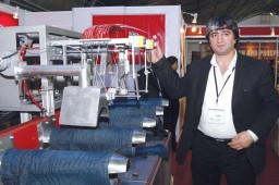 Abdullah Goek, General Manager, CeliKhan, with his automatic Jeans Crinkling Machine
