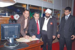 M.L. Jain from Mahaveer Industrial Suppliers and Anil Anand from HCA sign the anti-piracy book in support of the campaign headed by H.S. Passricha standing on right with a colleague