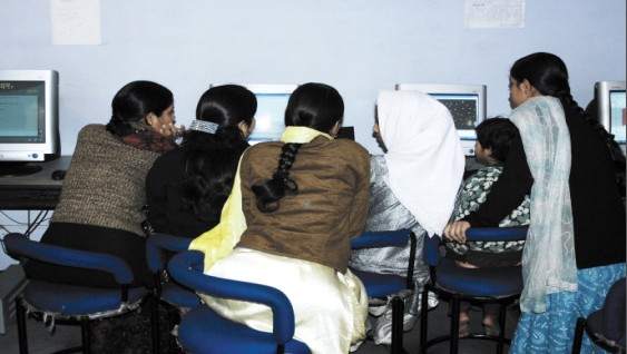 Women artisans operating the software