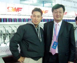 Cheol Kyu Kang with H M Lee of SWF with the embroidery machine