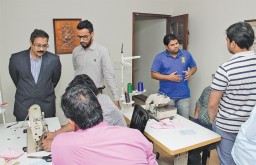 Chandrark Karekatti (extreme left), Head Projects and Training – Apparel Resources, explaining ‘Do It Yourself’ (DIY) exercises to participants with SNLS and overlock sewing machines, to help them understand concepts like Failure Mode Effects Analysis (FMEA), Autonomous Maintenance, Poka-Yoke and Kaizen
