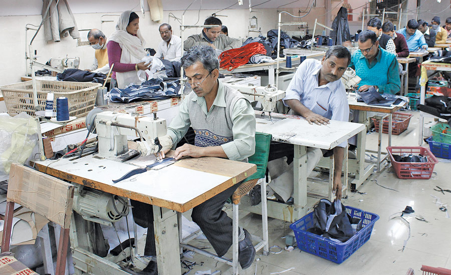 The sewing floor is arranged in modules of seven tailors, each tailor specializing in specific operations like sleeve making, and lining attaching