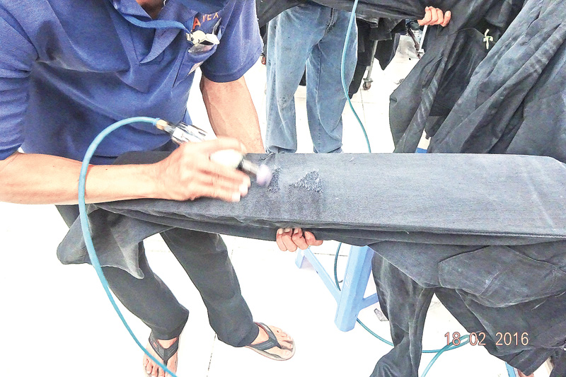 Mechanical scraping of denim for ‘controlled destruction’ of the fabric
