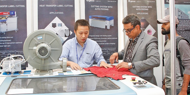 Abdullah AL Noman (R), Country Manager, GBOS Laser Inc. discussing technical details with Chinese counterpart